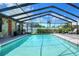 Enclosed turquoise swimming pool with stone accents, and outdoor seating at 2329 Duff Rd, Lakeland, FL 33810