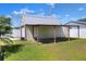 The shed has a practical design and is complemented by a lean-to, set against a lush lawn at 2329 Duff Rd, Lakeland, FL 33810