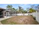 House exterior with backyard, screened in pool and white fencing at 2569 Colonel Ford Dr, Lakeland, FL 33813