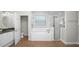 Bright bathroom featuring a soaking tub, glass-enclosed shower, and granite vanity at 2569 Colonel Ford Dr, Lakeland, FL 33813