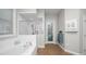 Bright bathroom featuring a soaking tub and a glass-enclosed shower with tile surround at 2569 Colonel Ford Dr, Lakeland, FL 33813