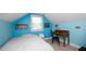 Attic bedroom with whitewashed floors features a study area and lots of natural light at 2569 Colonel Ford Dr, Lakeland, FL 33813