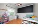 Bedroom features a toy shelf, a desk, and a chalkboard wall at 2569 Colonel Ford Dr, Lakeland, FL 33813