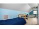 Bright bedroom boasts sleek wood-look floors, a study desk, and comfortable bed with natural light at 2569 Colonel Ford Dr, Lakeland, FL 33813