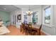 Charming dining area with hardwood floors, a stylish chandelier, and serene views of the outdoor pool area at 2569 Colonel Ford Dr, Lakeland, FL 33813