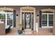 Inviting entryway featuring a decorative glass front door, sconces, and potted plants at 2569 Colonel Ford Dr, Lakeland, FL 33813