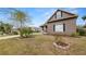 Well-maintained lawn with decorative rock and mature landscaping surrounding a stucco home at 2569 Colonel Ford Dr, Lakeland, FL 33813
