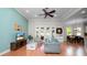 Bright living room features wood floors, high ceilings, and large windows that bring in natural light at 2569 Colonel Ford Dr, Lakeland, FL 33813