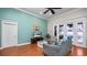 Comfortable living room showcasing a blue accent wall, wood flooring, and a ceiling fan at 2569 Colonel Ford Dr, Lakeland, FL 33813