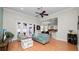 Open living room with wood floors, a ceiling fan, and seamless flow to the dining area at 2569 Colonel Ford Dr, Lakeland, FL 33813