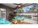 Enclosed patio featuring an in-ground pool, ceiling fan, and comfortable seating at 2569 Colonel Ford Dr, Lakeland, FL 33813
