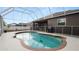 Inviting backyard screened pool for hot summer days with patio furniture and BBQ at 2569 Colonel Ford Dr, Lakeland, FL 33813