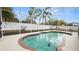 Relaxing screened-in pool with palm trees and white fencing for privacy at 2569 Colonel Ford Dr, Lakeland, FL 33813