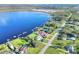Scenic aerial of waterfront home, manicured lawn, and tranquil lake setting at 2653 State Road 557, Lake Alfred, FL 33850