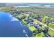Scenic aerial of lakefront home with lush landscaping and private boat dock at 2653 State Road 557, Lake Alfred, FL 33850
