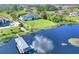 Expansive lakefront property featuring a well-maintained lawn and private dock with boat lift at 2653 State Road 557, Lake Alfred, FL 33850