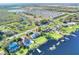 Stunning aerial view of a lakefront home, showcasing lush lawn and waterfront access at 2653 State Road 557, Lake Alfred, FL 33850