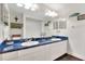 Bright bathroom showcasing double sinks with blue granite countertops and decorative wall art at 2653 State Road 557, Lake Alfred, FL 33850