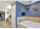 Bathroom featuring bathtub, walk in closet and vanity with countertop at 2653 State Road 557, Lake Alfred, FL 33850