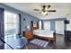 This bedroom features a ceiling fan, closet, light hardwood floors, and a blue accent wall at 2653 State Road 557, Lake Alfred, FL 33850