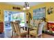 Stylish dining room with a glass table, seating for six, and a view of the outdoor patio at 2653 State Road 557, Lake Alfred, FL 33850