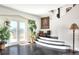 Inviting front foyer with French doors, hardwood floors, a decorative staircase, and a palm tree painting at 2653 State Road 557, Lake Alfred, FL 33850
