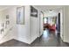 Hallway with hardwood floors, and view into living room featuring leather sofa at 2653 State Road 557, Lake Alfred, FL 33850