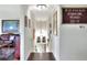 Hallway featuring hardwood floors, chandelier, paintings and motivational quote on the wall at 2653 State Road 557, Lake Alfred, FL 33850
