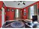 Inviting home office with rich, red walls and hardwood floors at 2653 State Road 557, Lake Alfred, FL 33850