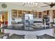 Open kitchen with stainless steel appliances, center island with counter seating, and wooden cabinetry at 2653 State Road 557, Lake Alfred, FL 33850