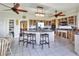 Spacious kitchen featuring tile floors, kitchen island with stools, and wooden cabinetry at 2653 State Road 557, Lake Alfred, FL 33850