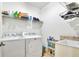 Functional laundry room with modern washer, dryer, and ample storage space at 2653 State Road 557, Lake Alfred, FL 33850