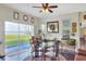 Living room featuring stylish decor, hardwood floors, a ceiling fan and sliding glass doors with beautiful view at 2653 State Road 557, Lake Alfred, FL 33850
