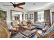 Comfortable living room featuring rattan furniture, a decorative mirror, and a cozy sofa at 2653 State Road 557, Lake Alfred, FL 33850