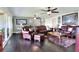 Comfortable living room features large windows for natural light, leather sofas, and hardwood floors at 2653 State Road 557, Lake Alfred, FL 33850