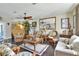 Inviting living room with rattan furniture, ceiling fan, and a large mirror reflecting the room's charm at 2653 State Road 557, Lake Alfred, FL 33850