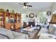 Cozy living room with hardwood floors, a fireplace, and large windows for natural light at 2653 State Road 557, Lake Alfred, FL 33850