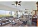 Elegant living room featuring hardwood floors, ceiling fans, and sliding glass doors with lake view at 2653 State Road 557, Lake Alfred, FL 33850