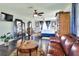 Spacious main bedroom features hardwood floors, a ceiling fan, a seating area and ample natural light at 2653 State Road 557, Lake Alfred, FL 33850