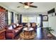Spacious main bedroom features hardwood floors, a ceiling fan, a seating area and ample natural light at 2653 State Road 557, Lake Alfred, FL 33850