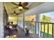 Covered patio with wicker furniture and ceiling fans, providing a relaxing outdoor space at 2653 State Road 557, Lake Alfred, FL 33850