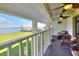 Covered patio overlooking the lake, featuring comfortable seating, ceiling fans and peaceful view at 2653 State Road 557, Lake Alfred, FL 33850