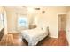 Well-lit bedroom with hardwood floors, neutral walls, ceiling fan, and window at 2816 Fairmount Ave, Lakeland, FL 33803