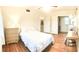 A cozy bedroom displays a queen-size bed, wooden floors, and built-in closet at 2816 Fairmount Ave, Lakeland, FL 33803