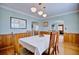 Bright and airy dining room showcasing a dining table set for six, hardwood floors and unique art at 2816 Fairmount Ave, Lakeland, FL 33803