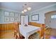Traditional dining room with wood paneling, hardwood floors, and elegant lighting fixtures at 2816 Fairmount Ave, Lakeland, FL 33803