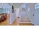 Inviting entryway features hardwood floors, a staircase with a decorative window, and dining area views at 2816 Fairmount Ave, Lakeland, FL 33803