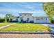 Charming two-story home boasts a well-manicured lawn and attached garage at 2816 Fairmount Ave, Lakeland, FL 33803
