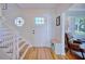 Inviting foyer with hardwood floors, staircase, and unique circular window with stained glass at 2816 Fairmount Ave, Lakeland, FL 33803