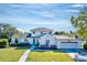 Charming two-story home with a well-maintained lawn, beautiful landscaping, and attached two-car garage at 2816 Fairmount Ave, Lakeland, FL 33803
